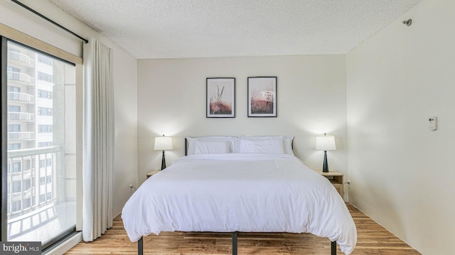 3101 Boardwalk Unit 1206-2, Atlantic City, NJ 08401 - bedroom featuring a textured ceiling, light wood finished floors, and access to exterior