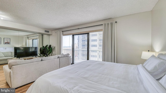 3101 Boardwalk Unit 1206-2, Atlantic City, NJ 08401 - bedroom with wood finished floors, a textured ceiling, and access to outside