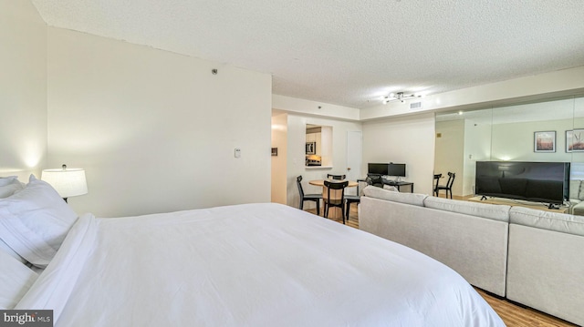 3101 Boardwalk Unit 1206-2, Atlantic City, NJ 08401 - bedroom featuring a textured ceiling, wood finished floors, and track lighting