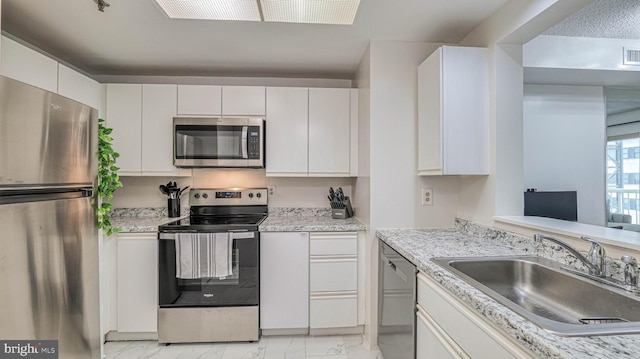 3101 Boardwalk Unit 1206-2, Atlantic City, NJ 08401 - kitchen with appliances with stainless steel finishes, a sink, light marble finish flooring, white cabinetry, and light countertops