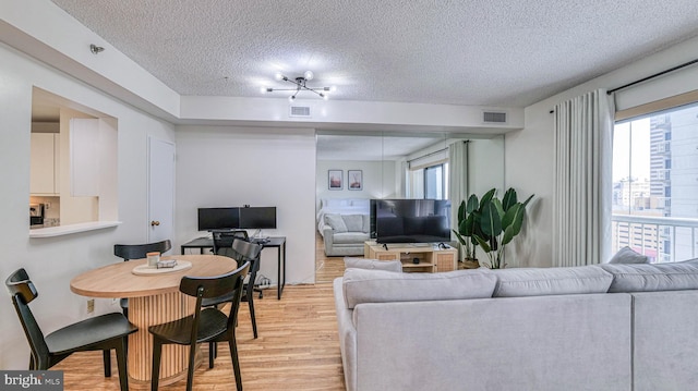 3101 Boardwalk Unit 1206-2, Atlantic City, NJ 08401 - living room with a textured ceiling, light wood-type flooring, and plenty of natural light