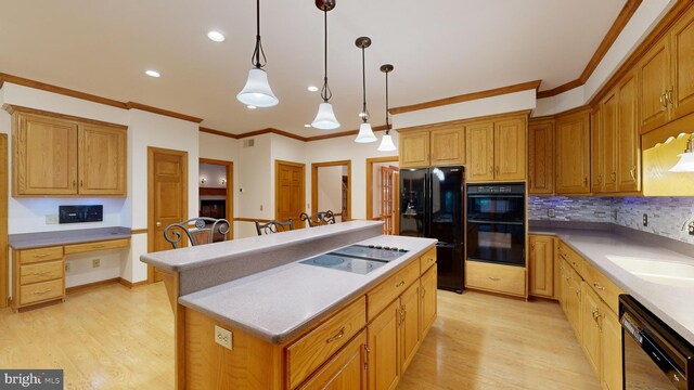 30751 Al Jan Dr, Laurel, DE 19956 - kitchen featuring black appliances, a sink, light wood-style floors, a center island, and crown molding