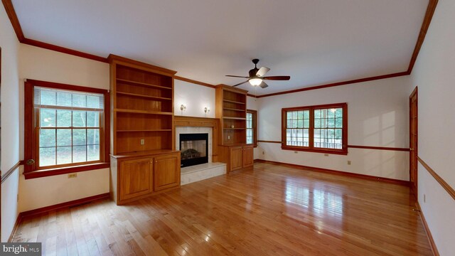 30751 Al Jan Dr, Laurel, DE 19956 - unfurnished living room with crown molding, a ceiling fan, baseboards, a fireplace, and light wood-style floors