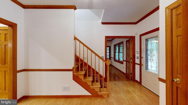 30751 Al Jan Dr, Laurel, DE 19956 - entryway with wood finished floors, crown molding, baseboards, and stairway