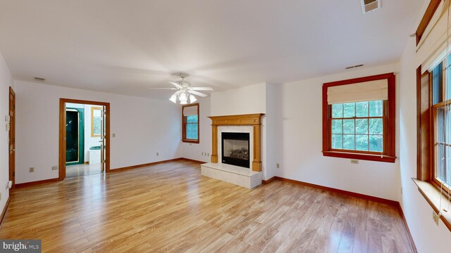 30751 Al Jan Dr, Laurel, DE 19956 - unfurnished living room featuring light wood-style flooring, a ceiling fan, a tile fireplace, and baseboards
