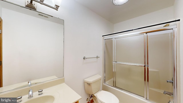 30751 Al Jan Dr, Laurel, DE 19956 - bathroom featuring vanity, bath / shower combo with glass door, and toilet