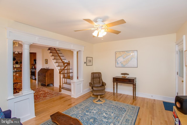 256 N Union St, Lambertville, NJ 08530 - living area featuring light wood-type flooring, a ceiling fan, stairway, and decorative columns