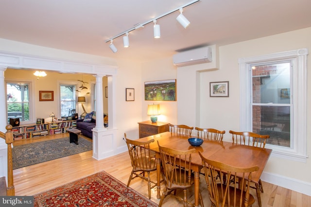 256 N Union St, Lambertville, NJ 08530 - dining room with a wall mounted air conditioner, decorative columns, track lighting, and light wood-type flooring
