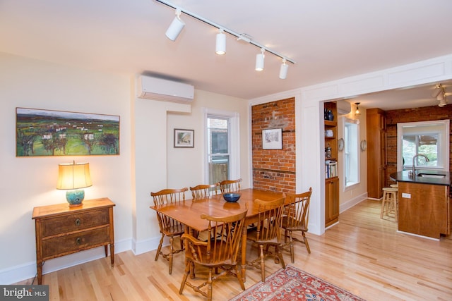256 N Union St, Lambertville, NJ 08530 - dining area featuring a wall unit AC, light wood finished floors, rail lighting, and baseboards