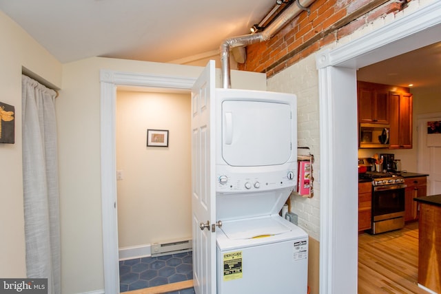 256 N Union St, Lambertville, NJ 08530 - laundry area with stacked washing machine and dryer, light wood finished floors, a baseboard heating unit, and brick wall