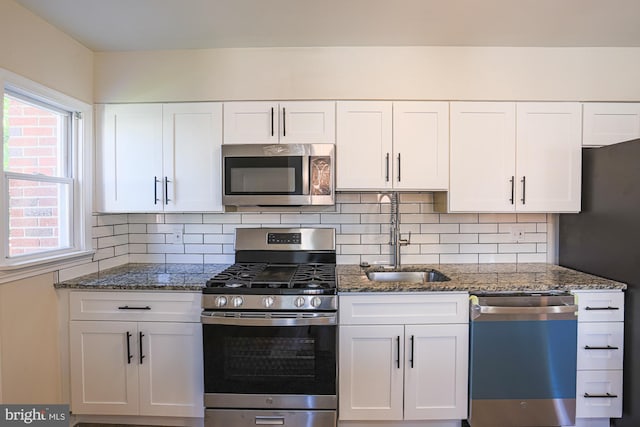 3958 Oakford Ave, Baltimore, MD 21215 - kitchen featuring stainless steel appliances, white cabinets, dark stone countertops, and backsplash