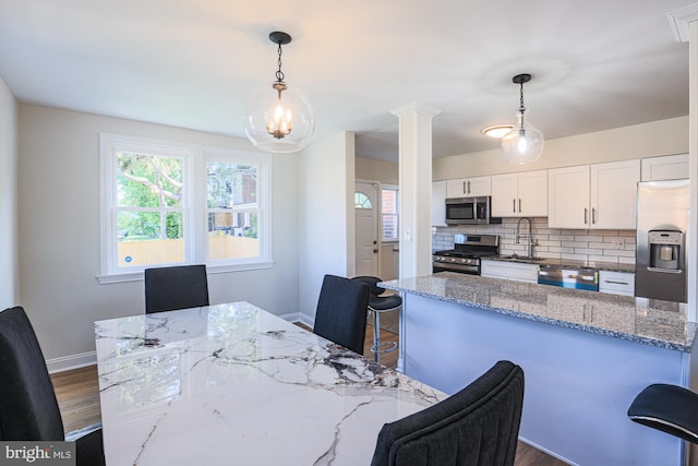 3958 Oakford Ave, Baltimore, MD 21215 - dining space featuring dark wood finished floors and decorative columns