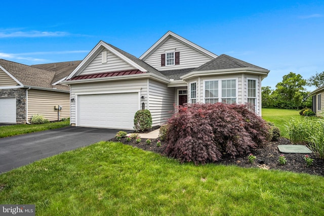 152 Independence Way, Mechanicsburg, PA 17050 - traditional home with an attached garage, asphalt driveway, a front lawn, a standing seam roof, and metal roof