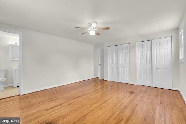 414 Lavender Hill Dr, Cherry Hill, NJ 08003 - unfurnished bedroom with two closets, light wood-style flooring, baseboards, ensuite bath, and a ceiling fan