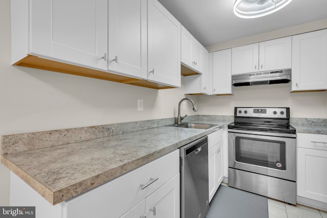 1458 Blockton Ct, Crofton, MD 21114 - kitchen with appliances with stainless steel finishes, under cabinet range hood, a sink, light countertops, and white cabinetry
