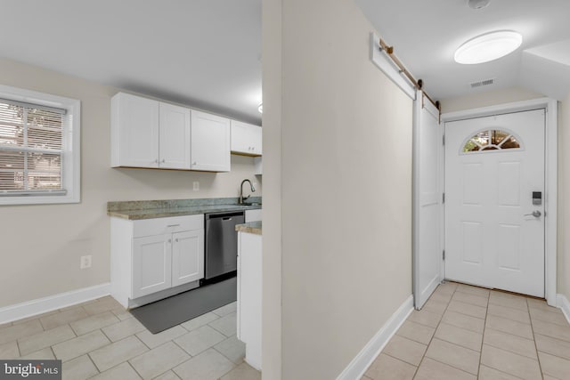 1458 Blockton Ct, Crofton, MD 21114 - kitchen with dishwasher, a barn door, light tile patterned flooring, white cabinets, and light countertops