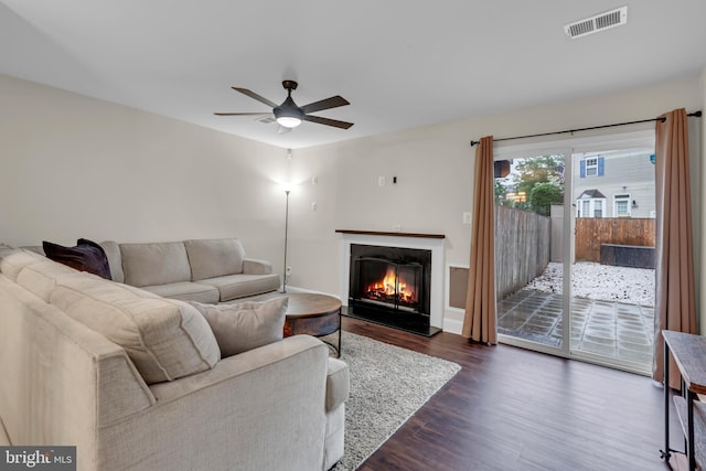 1458 Blockton Ct, Crofton, MD 21114 - living room with dark wood-style flooring, a ceiling fan, and a warm lit fireplace