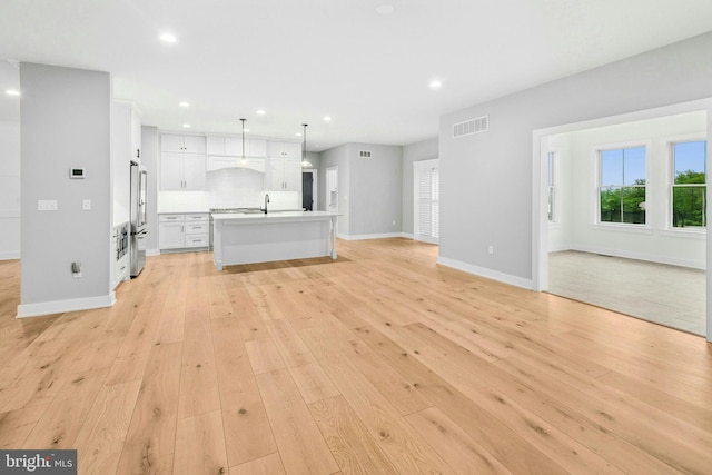 385 Nolf Rd, Nazareth, PA 18064 - unfurnished living room featuring baseboards, recessed lighting, light wood-style floors, and a sink