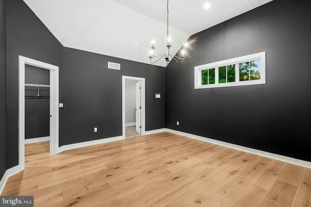 385 Nolf Rd, Nazareth, PA 18064 - unfurnished room with a chandelier, light wood-style flooring, high vaulted ceiling, and baseboards