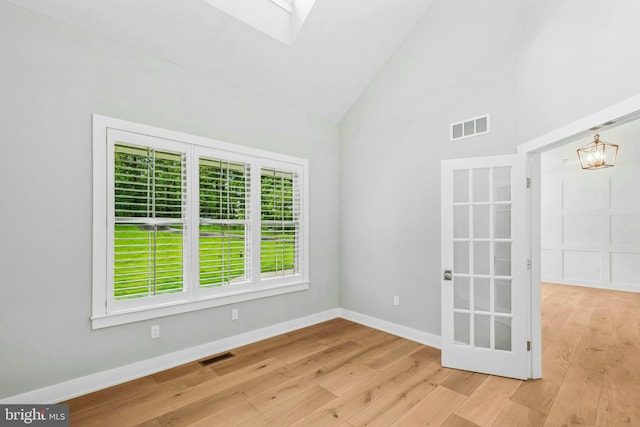 385 Nolf Rd, Nazareth, PA 18064 - empty room with high vaulted ceiling, hardwood / wood-style floors, a chandelier, baseboards, and a skylight