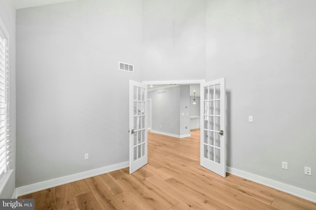 385 Nolf Rd, Nazareth, PA 18064 - spare room with french doors, light wood-style flooring, baseboards, and a towering ceiling