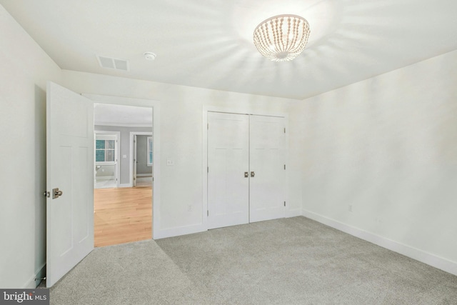 385 Nolf Rd, Nazareth, PA 18064 - unfurnished bedroom with light carpet, a chandelier, baseboards, and a closet