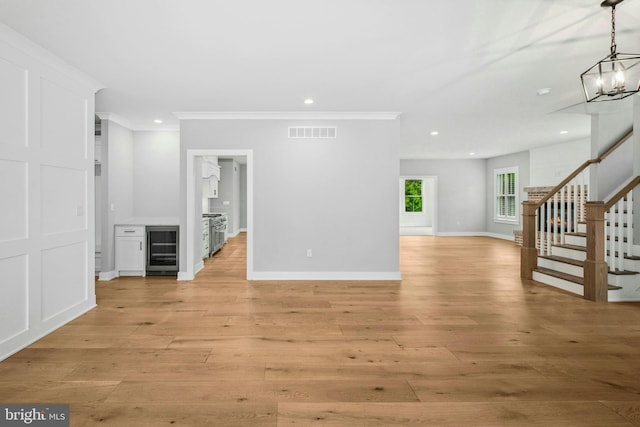 385 Nolf Rd, Nazareth, PA 18064 - unfurnished living room featuring beverage cooler, stairs, crown molding, recessed lighting, and light wood-style floors