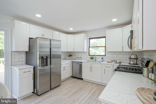 360 N Broad St, Clayton, NJ 08312 - kitchen with appliances with stainless steel finishes, a sink, light stone counters, tasteful backsplash, and white cabinets
