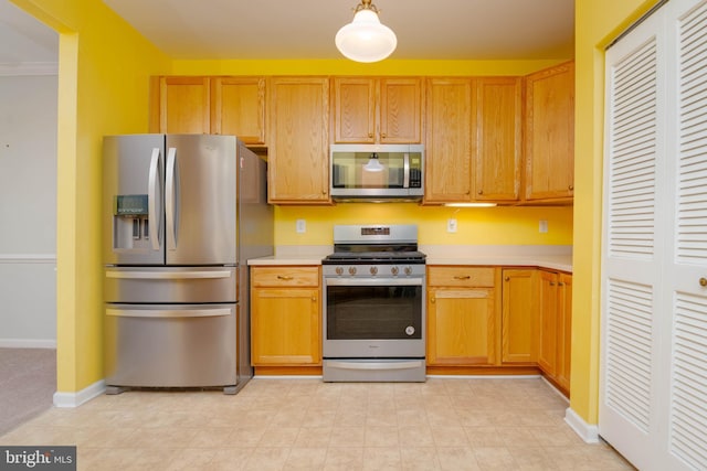 130 W Broadway Unit 1D, Bel Air, MD 21014 - kitchen featuring stainless steel appliances, light countertops, baseboards, and pendant lighting