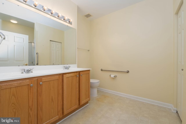 130 W Broadway Unit 1D, Bel Air, MD 21014 - bathroom with double vanity, toilet, baseboards, and a shower with door