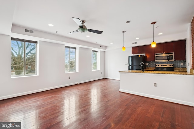 5401 9th St NW Unit 202, Washington, DC 20011 - kitchen featuring stainless steel appliances, a ceiling fan, backsplash, light stone countertops, and decorative light fixtures