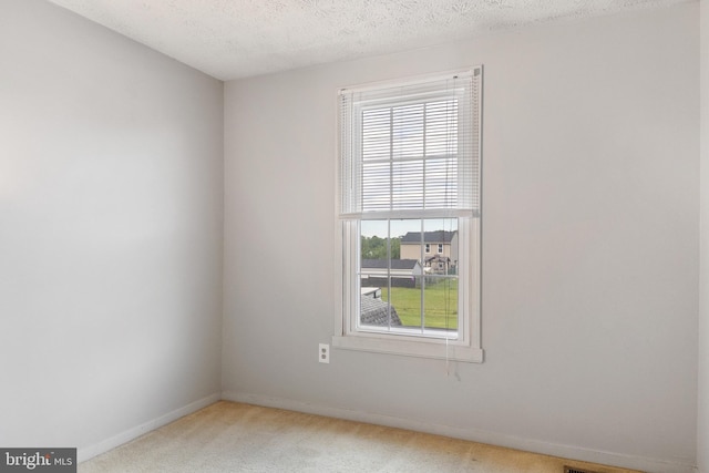 30 Towns Ct, Baltimore, MD 21237 - empty room with light colored carpet, baseboards, and a textured ceiling