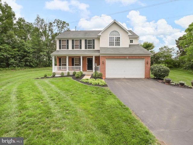 9499 Ballagan Ct, Bristow, VA 20136 - traditional-style house with covered porch, asphalt driveway, brick siding, and an attached garage