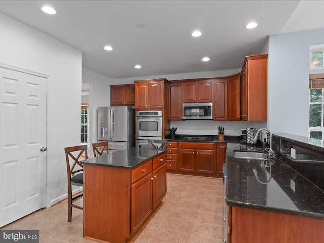 9499 Ballagan Ct, Bristow, VA 20136 - kitchen with stainless steel appliances, a sink, dark stone counters, recessed lighting, and light tile patterned floors