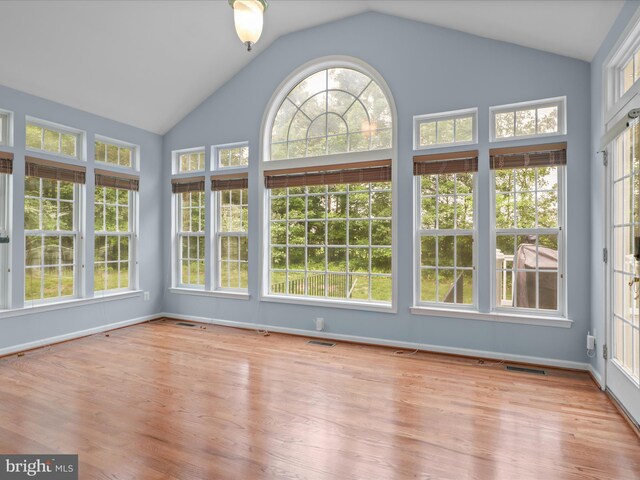 9499 Ballagan Ct, Bristow, VA 20136 - unfurnished sunroom featuring vaulted ceiling, wood finished floors, baseboards, and a wooden deck
