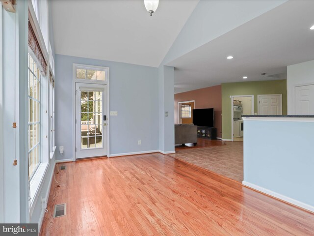 9499 Ballagan Ct, Bristow, VA 20136 - unfurnished living room with light wood-style floors, lofted ceiling, baseboards, and recessed lighting