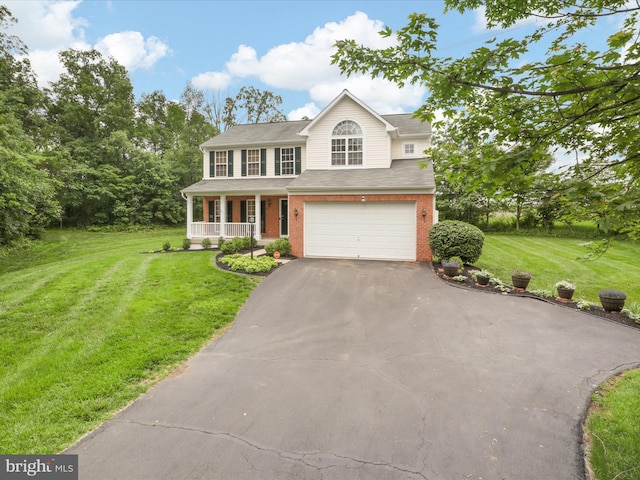 9499 Ballagan Ct, Bristow, VA 20136 - traditional-style house with a porch, asphalt driveway, an attached garage, brick siding, and a front lawn