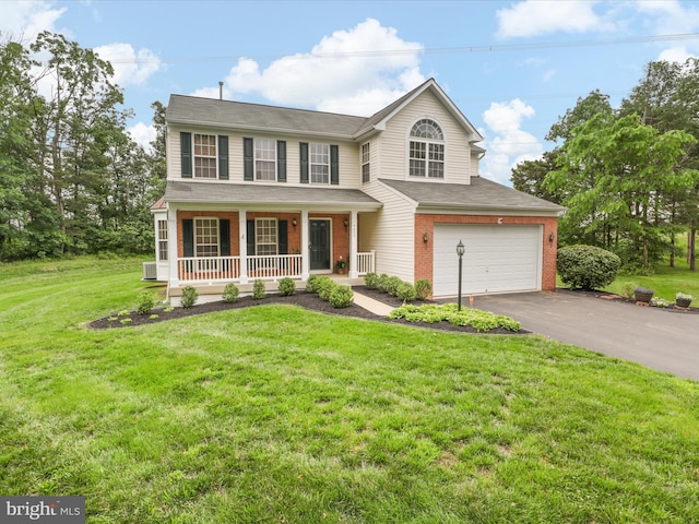 9499 Ballagan Ct, Bristow, VA 20136 - view of front of property with covered porch, driveway, a garage, brick siding, and a front yard