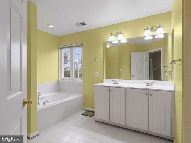 9499 Ballagan Ct, Bristow, VA 20136 - full bathroom with double vanity, a bath, tile patterned floors, and baseboards
