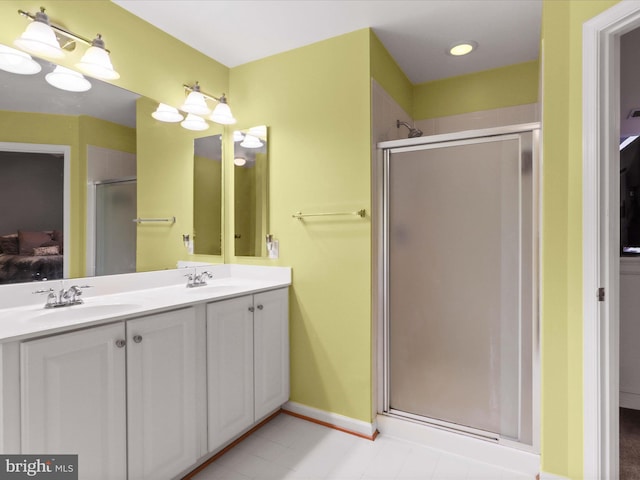 9499 Ballagan Ct, Bristow, VA 20136 - bathroom featuring a stall shower, ensuite bath, double vanity, and baseboards