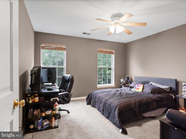 9499 Ballagan Ct, Bristow, VA 20136 - carpeted bedroom featuring multiple windows, a desk, baseboards, and a ceiling fan
