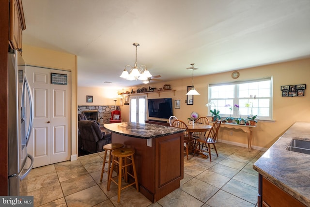 221 Shirley, Jeffersonville, PA 19403 - kitchen with stainless steel fridge, a kitchen breakfast bar, open floor plan, a chandelier, and brown cabinetry