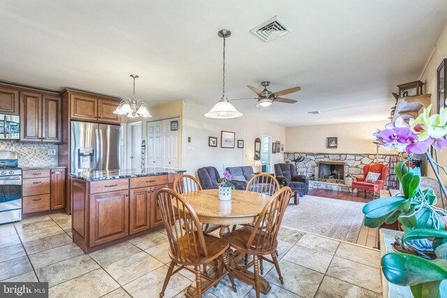 221 Shirley, Jeffersonville, PA 19403 - dining room with a ceiling fan, a fireplace, and a chandelier