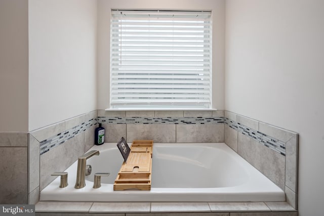 full bath featuring plenty of natural light and a garden tub