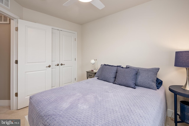 bedroom with a closet, carpet flooring, baseboards, and a ceiling fan