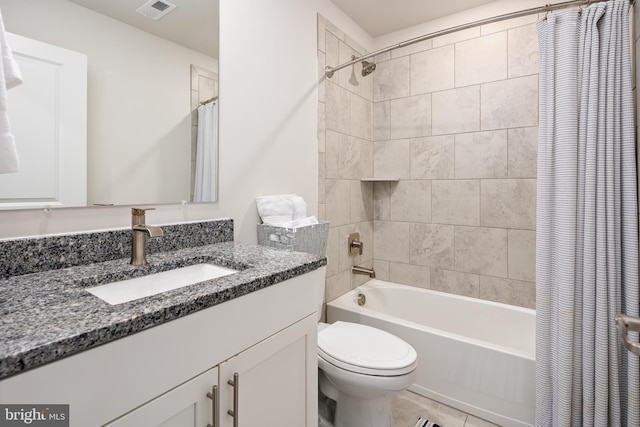bathroom featuring shower / tub combo, toilet, vanity, and tile patterned flooring
