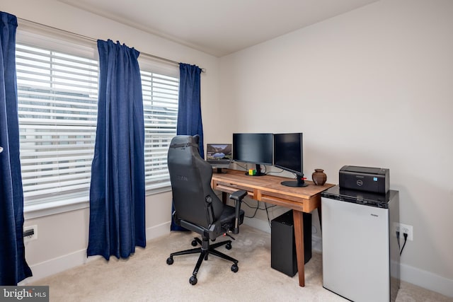 office space with baseboards and carpet flooring