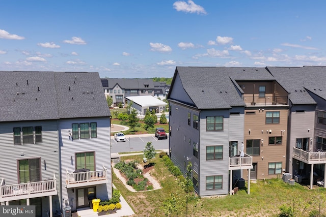 view of building exterior with a residential view and cooling unit