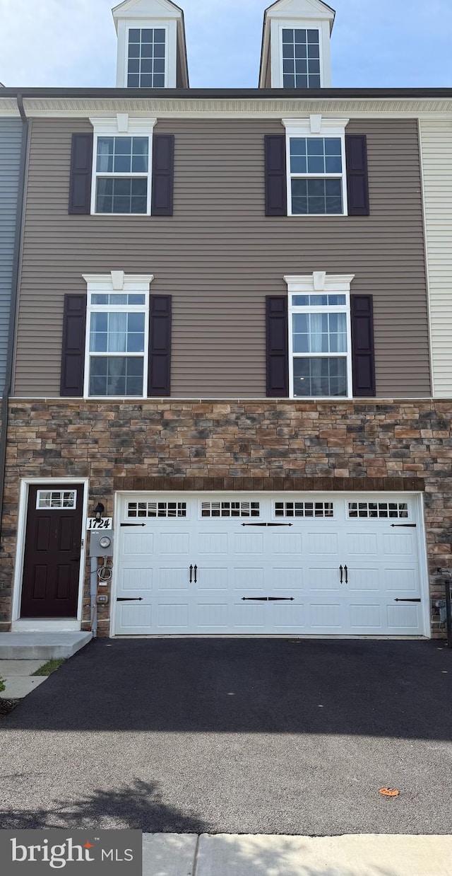 1724 Atlas Dr, Frederick, MD 21702 - view of front of home featuring stone siding, an attached garage, and driveway