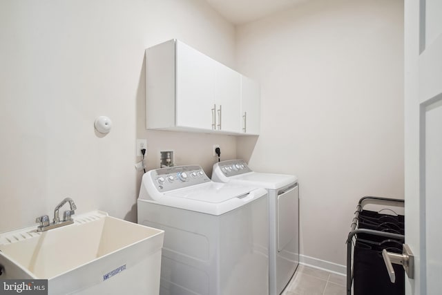 1724 Atlas Dr, Frederick, MD 21702 - laundry room featuring independent washer and dryer, cabinet space, light tile patterned flooring, and baseboards